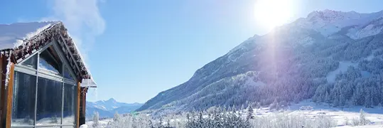 Chalet avec un paysage de montagne enneigée en fond