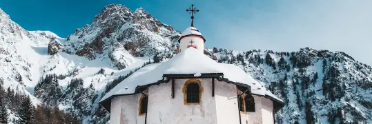 Chapelle entre les montagnes enneigées